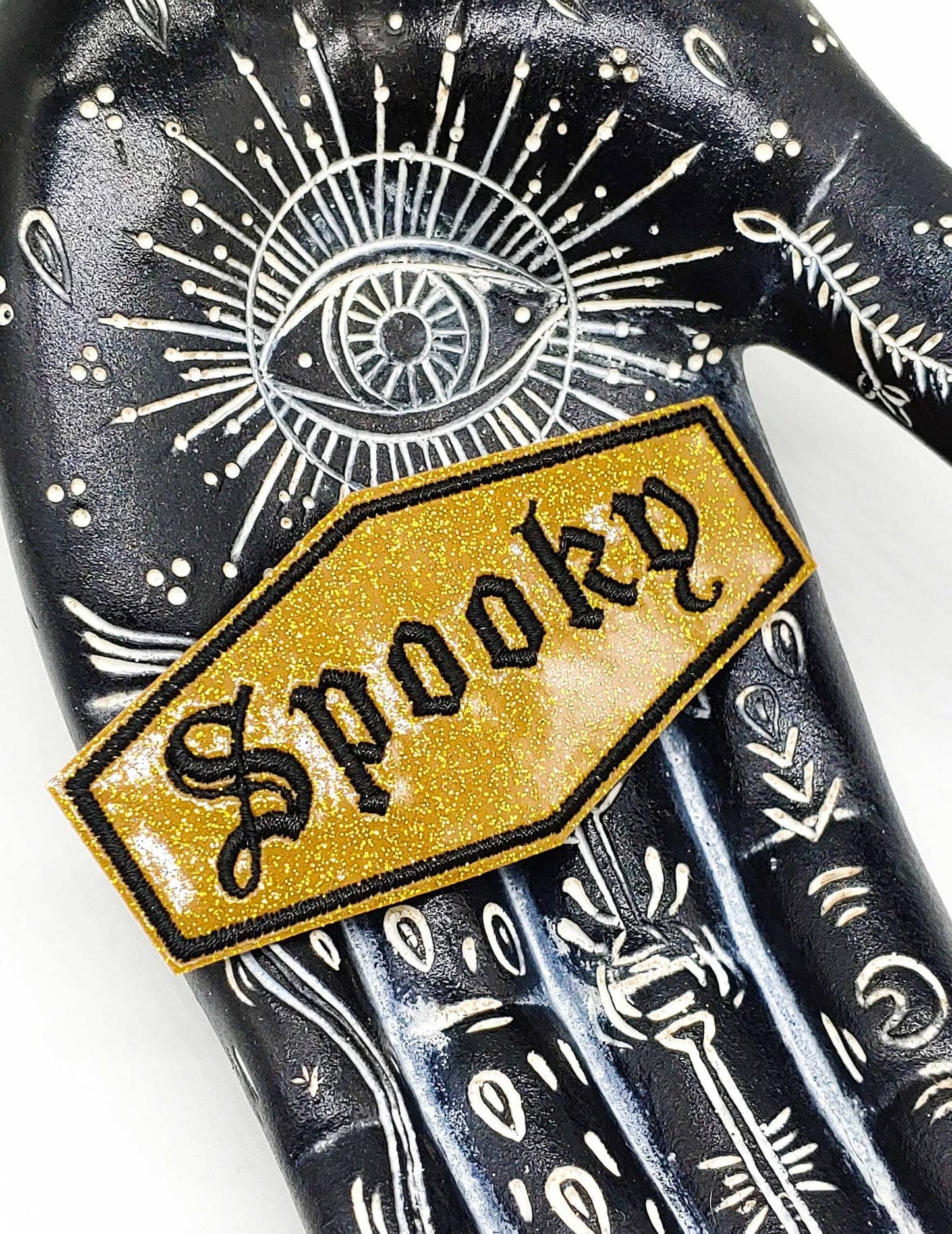 
                  
                    Spooky Gold and Black Glitter Vinyl Embroidered Patch
                  
                