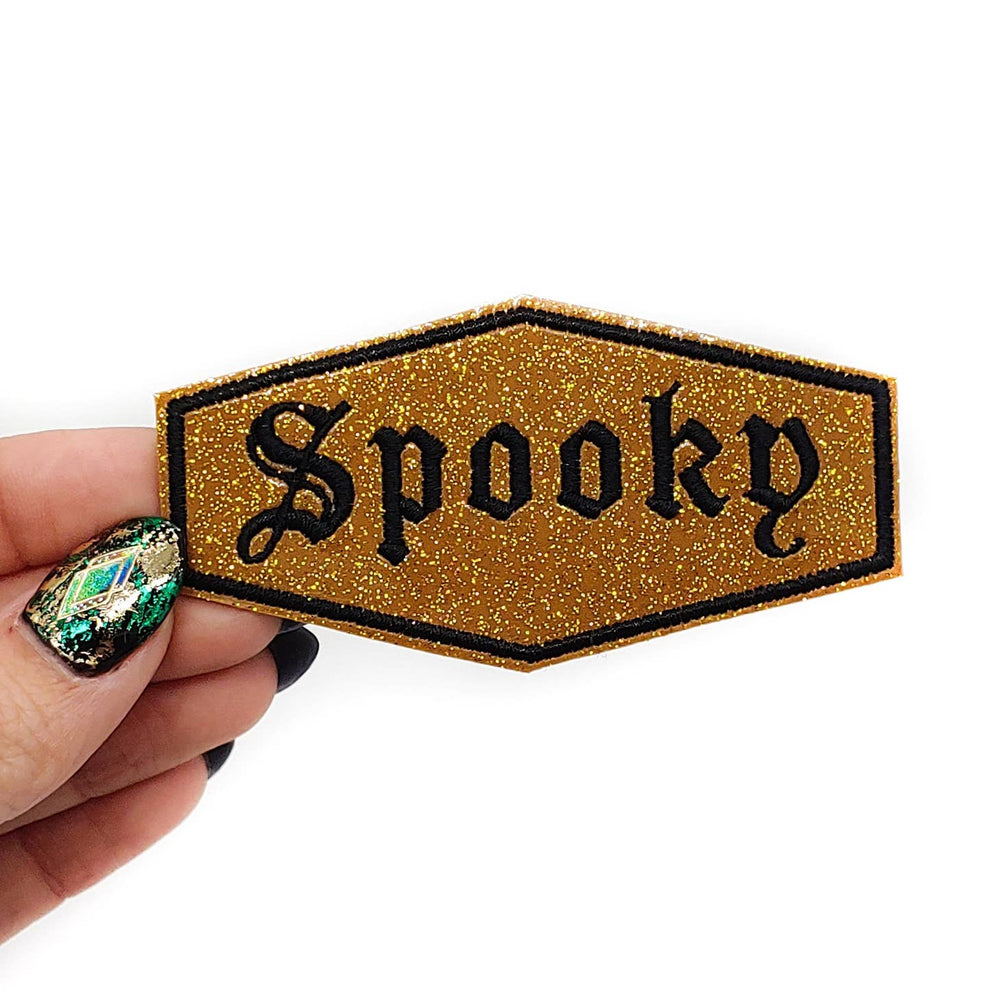 
                  
                    Spooky Gold and Black Glitter Vinyl Embroidered Patch
                  
                